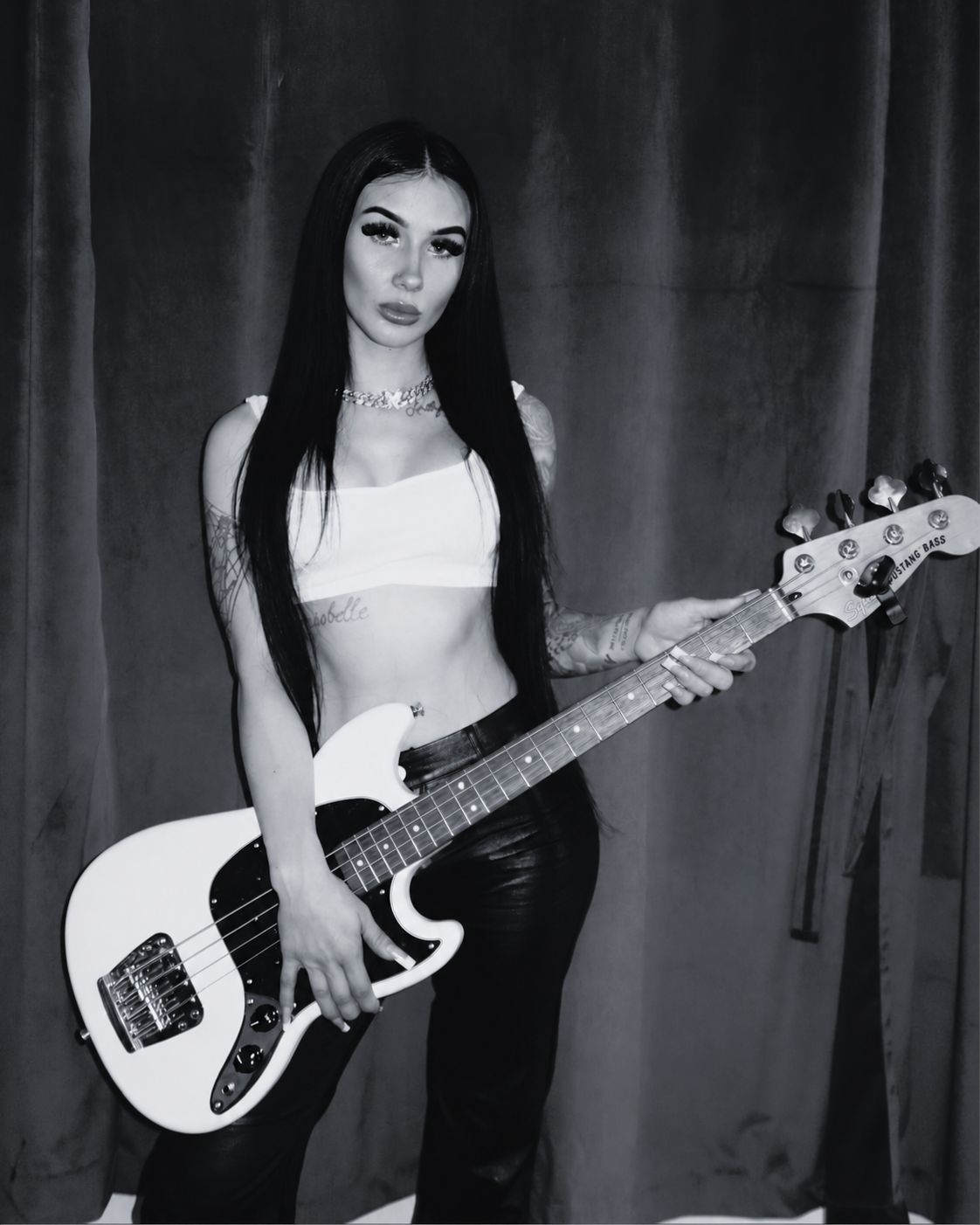 HollyBear standing with her bass guitar